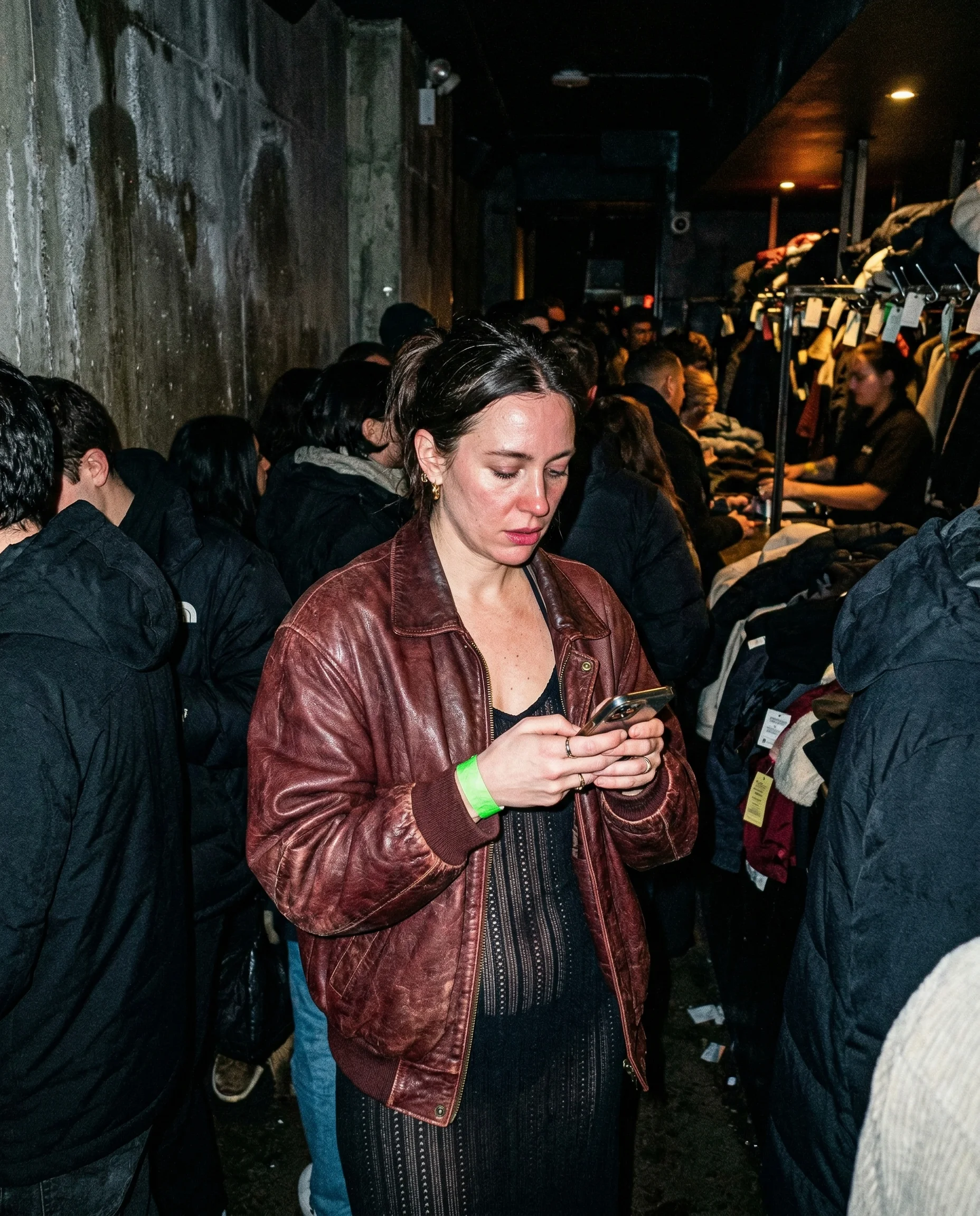 leather bomber and neon wristband coat check